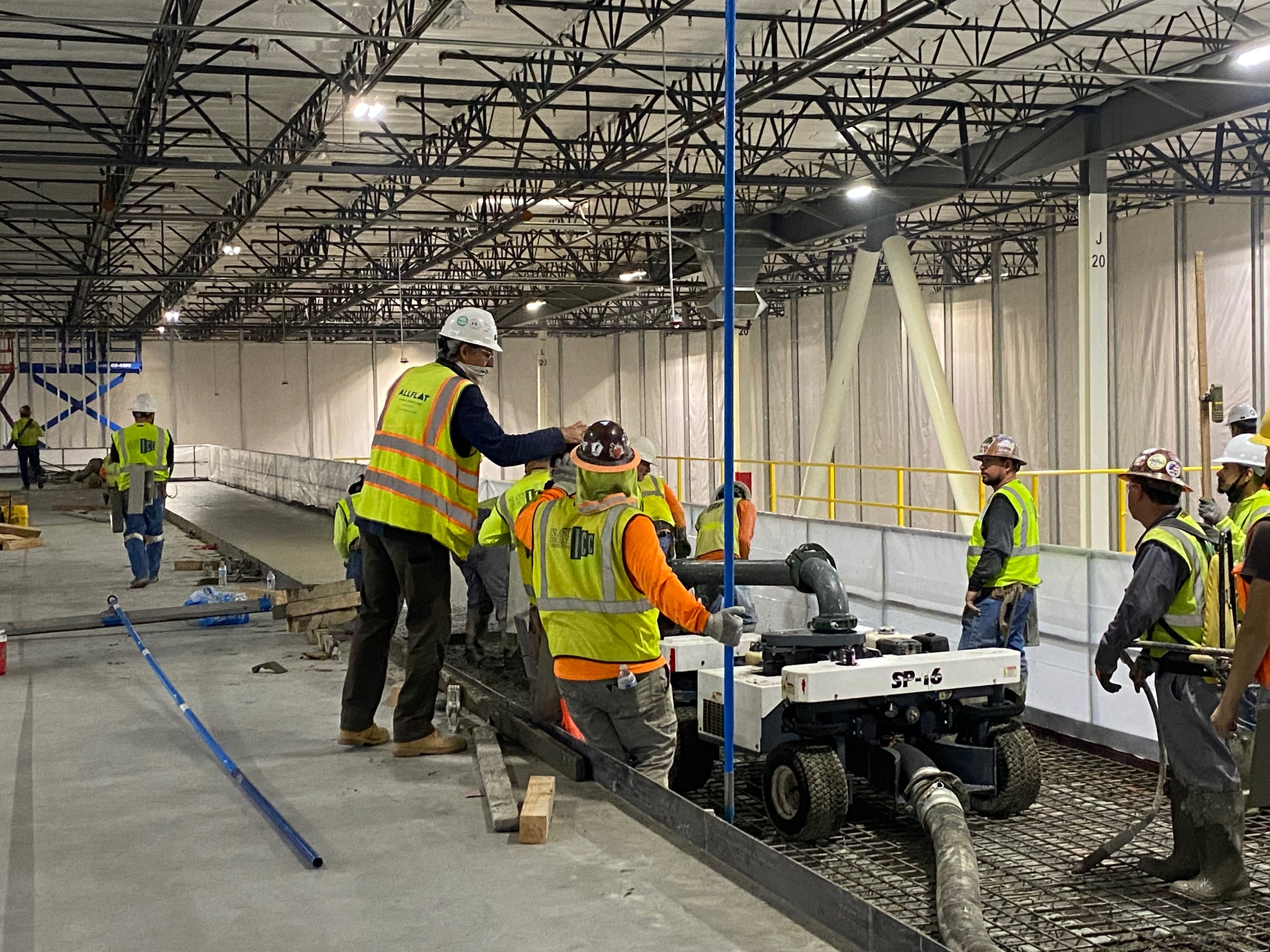 AllFlat Workers working on a concrete floor